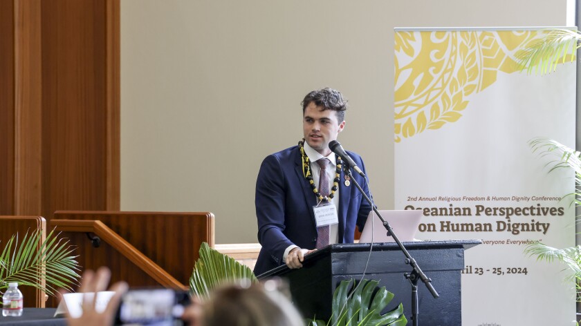 A man speaks at a podium