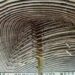 A ceiling of woven organic material in a spiral shape