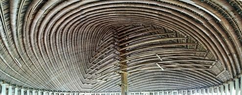 A ceiling of woven organic material in a spiral shape