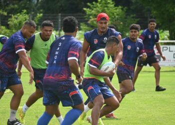 Manu Samoa Sevens players wearing navy blue training tops and red bibs train as a group at the Oceania Pre Games training camp.