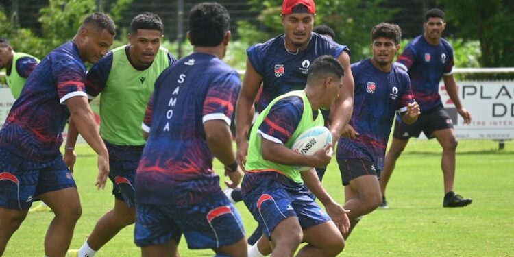Manu Samoa Sevens players wearing navy blue training tops and red bibs train as a group at the Oceania Pre Games training camp.