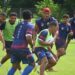 Manu Samoa Sevens players wearing navy blue training tops and red bibs train as a group at the Oceania Pre Games training camp.